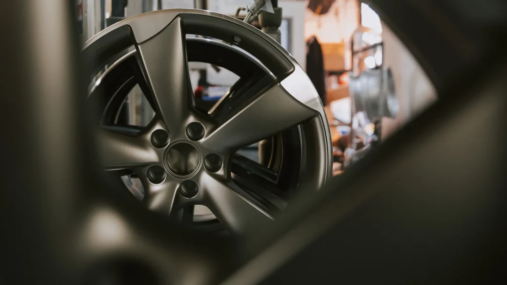 Alloy wheel being quality inspected after refurbishment at Autoshine Alloy Wheel clinic Cornwall